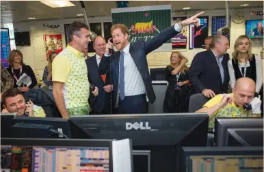  ?? (Geoff Pugh/Reuters) ?? BRITAIN’S PRINCE HARRY takes part in a charity trading day at ICAP in support of his charity, Sentebale, yesterday in London.