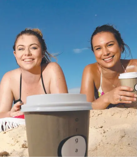  ?? Picture: SCOTT FLETCHER ?? Giverny Oryl, 20, and Nicole Schneider, 21, from Brisbane sip their coffees on Main Beach.