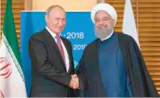  ?? — AFP ?? Russian President Vladimir Putin meets with Iranian President Hassan Rouhani on the sidelines of the SCO Summit in Qingdao on Saturday.