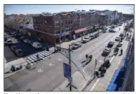  ?? (AP/Brittainy Newman) ?? Viewed from a roof, caution tape covers the corner where pedestrian­s were struck on Monday in Bay Ridge, in the Brooklyn borough of New York.