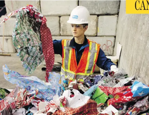  ?? DAVID BLOOM / POSTMEDIA NEWS / QMI AGENCY FILES ?? Alyson Winkelaar of Edmonton Waste Management Services shows some of the metallic wrapping paper that shouldn’t go in blue recycle bins.