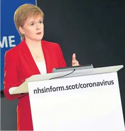  ?? Picture: PA. ?? Top: Coronaviru­s-related graffiti on a wall in Glasgow – Scots are being reminded that the Stay At Home message remains in force over the bank holiday weekend. Above: Nicola Sturgeon clarified points arising from the publicatio­n of the lockdown exit strategy document.