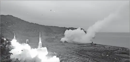  ?? [SOUTH KOREA DEFENSE MINISTRY] ?? In this photo provided by South Korea Defense Ministry, South Korea’s Hyunmoo II Missile system, left, and the U.S. Army Tactical Missile System, right, fire missiles during a combined military exercise at an undisclose­d location Saturday.