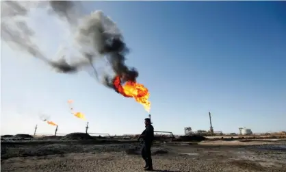  ??  ?? A policeman at West Qurna-1 oil field, which is operated by ExxonMobil, in Basra, Iraq. Photograph: Essam Al Sudani/Reuters