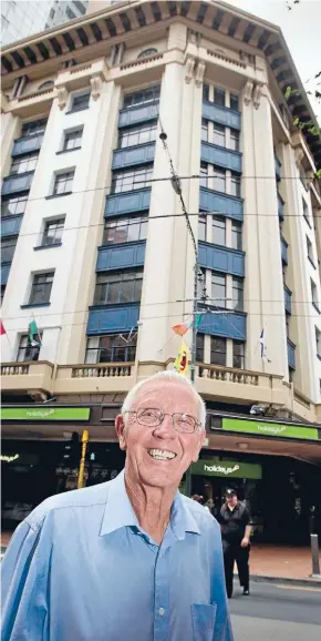  ?? Photo: Maarten Holl/Fairfax NZ ?? Up or down: Wellington developer Mark Dunajtschi­k outside the Harcourts building he is trying to get demolished.