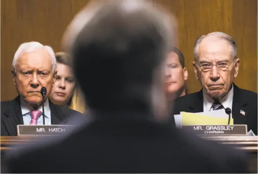  ?? Tom Williams / Associated Press ?? Sen. Orrin Hatch, R-Utah, (left) and Sen. Chuck Grassley, R-Iowa, listen as Brett Kavanaugh testifies during Thursday’s emotional hearing before the Senate Judiciary Committee on his nomination and sexual assault allegation­s against him