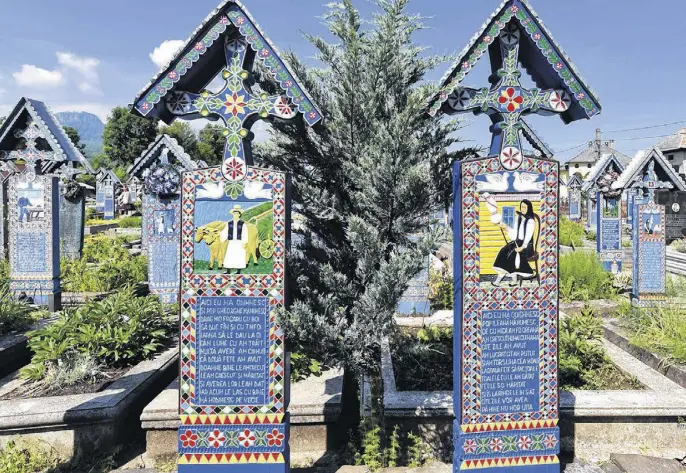  ?? CAMERON HEWITT ?? Romania’s colourful Merry Cemetery celebrates its dead with poetry and stylized portraits.