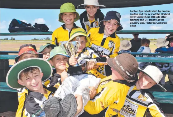  ?? ?? Ashton Bye is held aloft by brother Jordon and the rest of the Herbert River Cricket Club U11 side after claiming the U11 trophy at the Country Cup. Pictures: Cameron Bates