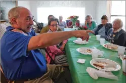  ?? MATT DAHLSEID/THE NEW MEXICAN ?? Joshua Cohen, left, talks about changes in the neighborho­od as a group of longtime neighbors on Camino Chueco gather Monday for lunch at the home of Eleanor Riser.