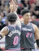  ?? LYNNE SLADKY/AP ?? Heat center Hassan Whiteside (21) celebrates with guard Josh Richardson (0) after scoring during the first half Friday.