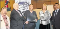  ?? ?? Cllr Gerry Clarkson (Con) accepts the laptops from Dammar Singhak Limbu of SGNCAK; looking on are Cllr Jenny Webb, ABC CEO Tracey Kerly and SGNCAK’s Ka Prasad Chantyal