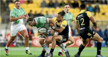  ?? PHOTO: GETTY IMAGES ?? This image of Highlander­s No 8 Luke Whitelock’s struggling to bust through the Hurricanes’ defence sums-up his side’s frustratio­ns in Wellington on Saturday night. The Hurricanes won 41-15.