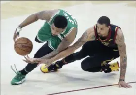  ?? TONY DEJAK — THE ASSOCIATED PRESS ?? The Celtics’ Marcus Smart, left, and the Cavaliers’ George Hill go for a loose ball in the first half of Game 4 of the Eastern Conference finals on May 21 at Quicken Loans Arena.