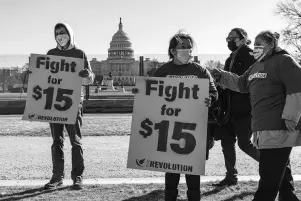  ?? The Associated Press ?? Activists appeal for a $15 minimum wage Thursday near the Capitol in Washington. The $1.9 trillion COVID-19 relief bill being prepped in Congress includes a provision that over five years would hike the federal minimum wage to $15 an hour.