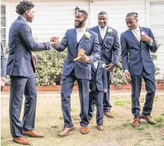  ??  ?? Taylor Washington talks with his groomsmen before his wedding at The Manor at Coffee Creek in Edmond.