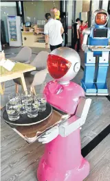  ?? Picture: GETTY IMAGES ?? NO NEED TO CATCH THEIR EYE: Robot waiters running along a fixed track between tables serve meals at a restaurant in Yiwu, China