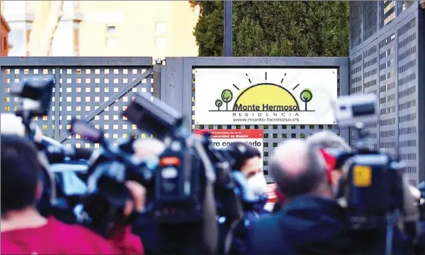  ?? AFP ?? Journalist­s gather at the entrance of the Monte Hermoso residence for the elderly in Madrid.