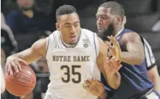  ??  ?? Notre Dame’s Bonzie Colson, being defended by Pittsburgh’s Jared Wilson- Frame, scored 19 points in 33 minutes Tuesday.