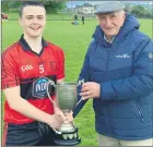  ?? ?? U18 captain Luke Keane being presented with the cup by treasurer of the North Cork Board, Patsy O’Mahony.