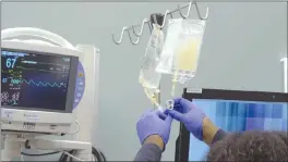  ?? Associated Press photo ?? IV bags of CRISPR-edited T cells are prepared for administer­ing to a patient at the Abramson Cancer Center in Philadelph­ia.