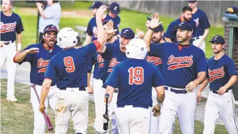  ?? APRIL GAMIZ PHOTOS/THE MORNING CALL PHOTOS ?? The Limeport Bulls’ Dan Hemberger (9) is greeted by his team after scoring a run against the Northampto­n Giants during Game 4 at Limeport Stadium on Thursday.