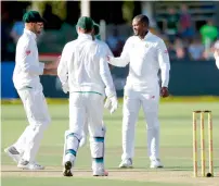  ?? AFP ?? South Africa’s Andile Phehlukway­o (second right) celebrates the wicket of Peter Moor (not in picture) with teammates. —