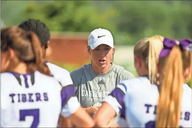  ?? Steven Eckhoff ?? Darlington head coach Anna Swafford talks with her team during the team’s season opener against Coosa at Darlington School. The former Darlington player took over the softball program back in May.