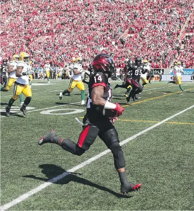  ?? GAVIN YOUNG / POSTMEDIA NEWS ?? Calgary Stampeders return man Roy Finch runs back a kickoff for a touchdown during the first half of the Labour Day Classic against Edmonton Eskimos in Calgary. The Stampeders won the sixth straight meeting in the all-Alberta rivalry.