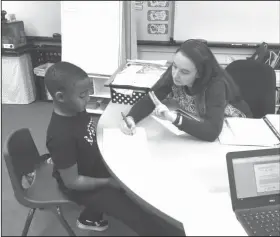  ??  ?? Practicing: Paraprofes­sional Julie Battisto works with first-grader Jordan McGhee.
