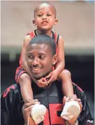  ??  ?? Lorenzen Wright holds his then 3-year-old son, Lorenzen Wright Jr., while talking to campers at the 1998 Lorenzen Wright City of Memphis Basketball Camp. Lorenzen Wright Jr., now 23, defended his mother Sherra Wright in an interview with the Los Angles Times about his father's slaying. ALAN SPEARMAN / FILE THE COMMERCIAL APPEAL