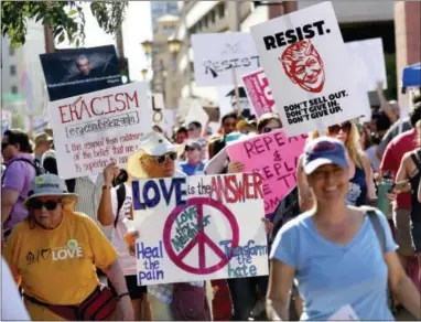  ?? MATT YORK — THE ASSOCIATED PRESS ?? People protest outside the Phoenix Convention Center, Tuesday in Phoenix. Protests were held against President Donald Trump as he hosted a rally inside the convention center.