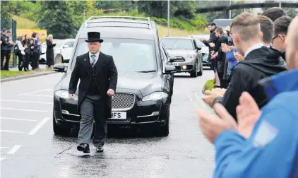  ??  ?? Farewell friend Teachers, pupils and parents of Calderglen lined the route of Gregor’s funeral procession