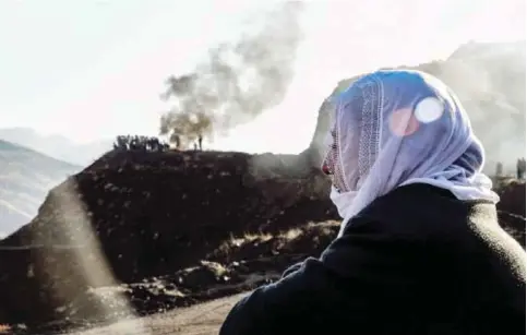  ??  ?? SIIRT, Turkey: A woman waits as rescue workers searching for trapped miners yesterday at the accident site in Siirt. Turkish rescue workers were yesterday battling to save 13 miners trapped after the collapse of a copper mine already confirmed to have...