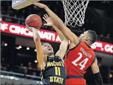  ?? [GARY LANDERS/THE ASSOCIATED PRESS] ?? Wichita State’s Landry Shamet attempts a shot against Cincinnati’s Kyle Washington during Sunday’s game.