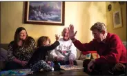  ?? NWA Democrat-Gazette/CHARLIE KAIJO ?? Mark Linkous (right) high-fives his great-granddaugh­ter Audrey Gilchrist, 3, as his daughter Debbie Gilchrist (left) and wife Ann Linkous hang out at Gilchrist’s home in Rogers. Each Thursday, Ann joins her daughter, granddaugh­ter and...