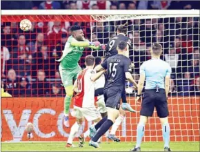  ?? AFP ?? Benfica forward Darwin Nunez (centre right) goes for a header and scores a goal against Ajax Amsterdam goalkeeper Andre Onana during the UEFA Champions League round of 16 second leg football match on Tuesday.