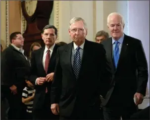  ?? The Associated Press ?? CAPITOL HILL: Senate Majority Leader Mitch McConnell, R-Ky., flanked by Sen. John Barrasso, R-Wyo., left, and Majority Whip John Cornyn, R-Texas, arrive to speak with reporters Tuesday at the Capitol in Washington. The White House and Republican...