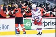  ?? Matt Slocum / Associated Press ?? The Flyers’ Kevin Hayes celebrates his goal with teammates as the Rangers’ Brendan Smith skates away.