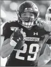  ?? JIM YOUNG/AP ?? Northweste­rn running back Evan Hull smiles as he rushes for one of his four touchdowns Saturday against UMass at Ryan Field.