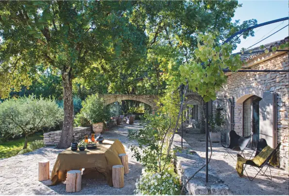  ??  ?? GARDEN
Maturing trees (above), planted more than a decade ago, o≠er welcome shade for al fresco meals taken around a rustic table. Hardoy Butterfly chair, from £850, Jorge Ferrari Hardoy at The Conran Shop, conranshop.co.uk.