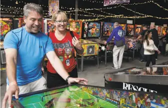 ?? Gabriella Angotti-Jones / The Chronicle ?? Jim Derby and Ellyn Derby play a pinball machine at the Pacific Pinball Museum in Alameda. Interest has skyrockete­d, with the number of players and competitio­ns growing worldwide.