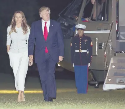  ?? AP PHOTO ?? WELCOME BACK: President Trump and first lady Melania Trump walk from Marine One across the South Lawn to the White House on Saturday as they return from the president’s first overseas trip.