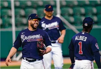  ?? BRYNN ANDERSON/ ASSOCIATED PRESS ?? Jason Kipnis, a former All- Star second baseman with the Indians trying to make the Braves roster, laughs with Ozzie Albies during spring training in North Port, Florida.