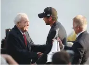  ?? ASSOCIATED PRESS FILE PHOTO ?? Arnold Palmer, left, congratula­tes Jason Day, center, of Australia, after Day won the 2016 Arnold Palmer Invitation­al. Palmer died in September