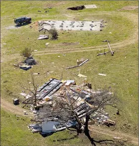  ?? Arkansas Democrat-Gazette/BENJAMIN KRAIN ?? This mobile home in the Searcy County town of St. Joe was blown off its foundation and into a tree Monday night by a tornado that cut a swath through parts of Searcy and Newton counties.