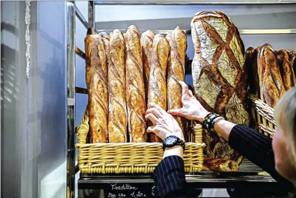  ?? AFP ?? The country of 67 million people consumes nine billion of the long loaves every year, has an annual competitio­n for the best baguette in Paris, and a special word for the pointy end they chew off on their way home from the baker after work – the crouton.