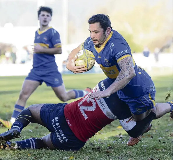  ?? PHOTO: GERARD O’BRIEN ?? Desperate defence . . . Taieri replacemen­t TeKorohi Rupene is stopped by Harbour midfield back Willie Tufui just short of the line at Peter Johnstone Park on Saturday.