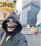  ??  ?? Robert Atack dressed as the Grim Reaper during a recent protest in Wellington.
Vandals also targeted the Tararua Pharmacy.