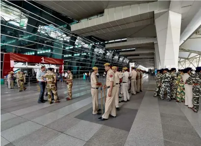  ?? PTI ?? Security personnel stand guard at the IGI airport where Shiv Sena MP Ravindra Gaikwad was about to arrive to catch a flight in New Delhi on Friday. —