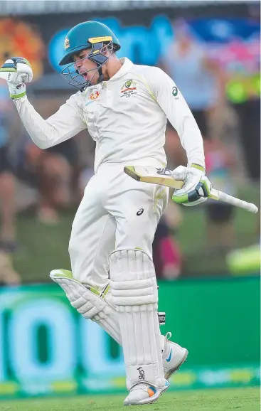  ?? Picture: PHIL HILLYARD ?? HE’S BACK: Australian batsman Usman Khawaja celebrates his century in the second Test against Sri Lanka yesterday at Canberra’s Manuka Oval,